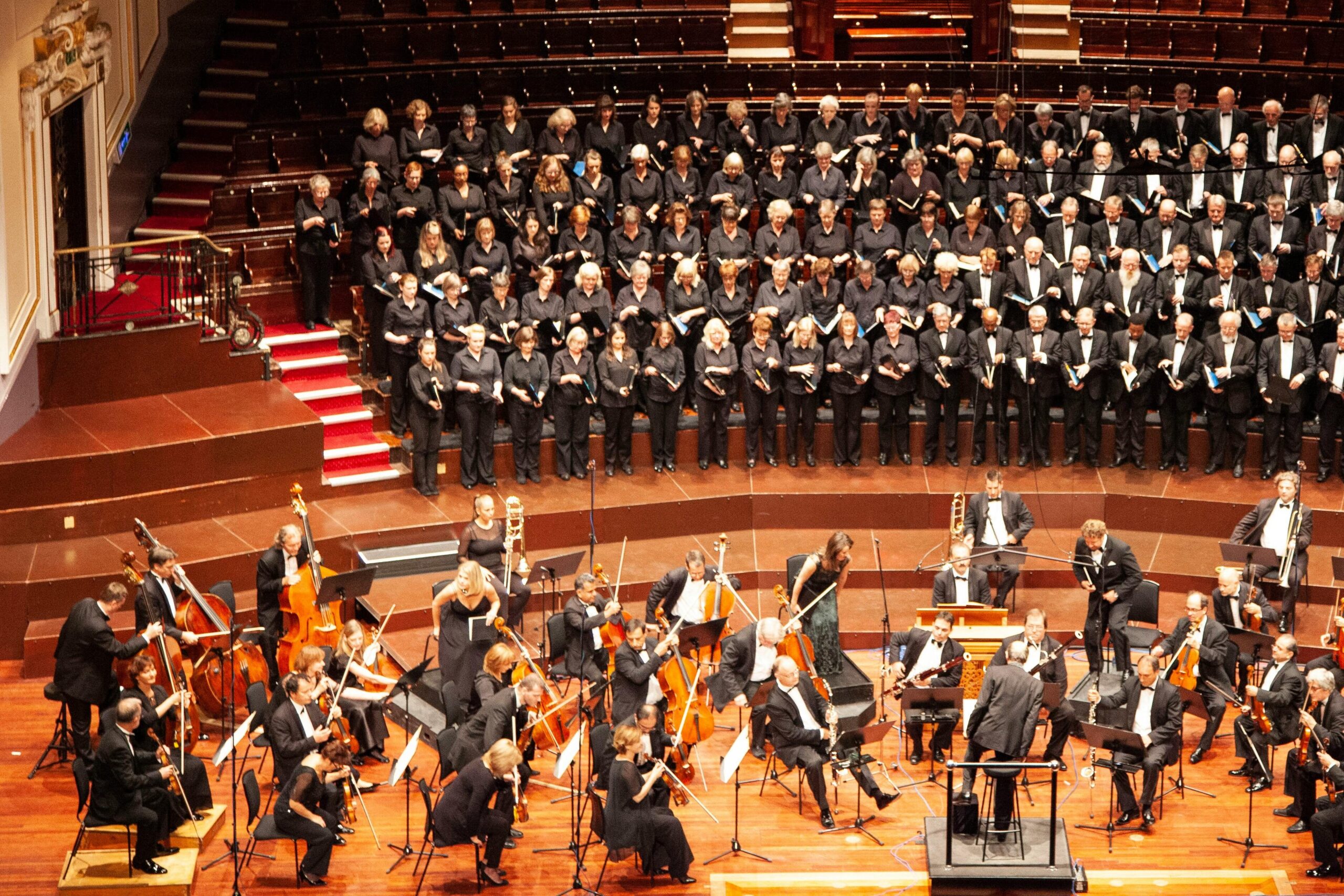 A majestic orchestra and choir performing at a historic venue in Edinburgh, Scotland.